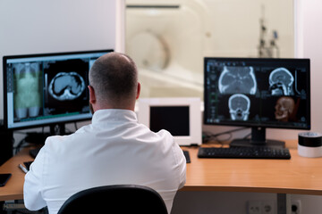 the patient undergoes computed tomography in the clinic the radiologist monitors the procedure and...