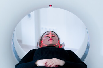 The patient undergoes computer tomography in the hospital scanner high-tech equipment and...