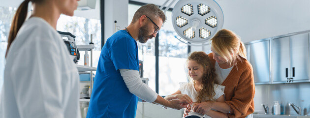 Little girl with her mother in surgery examination.