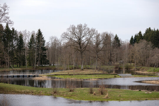 A small island in the middle of a lake with a bridge in the middle