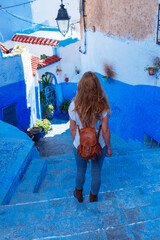 Woman tourist walking in Chefchaouen- blue city in Morocco