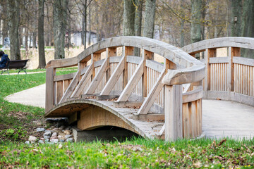 A bridge is made of wood and has a curved design.