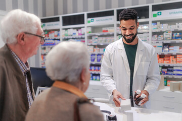 Young pharmacist selling medications to senior couple.