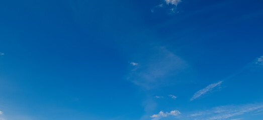 Naklejka na ściany i meble The blue sky with light clouds. Wide photo.
