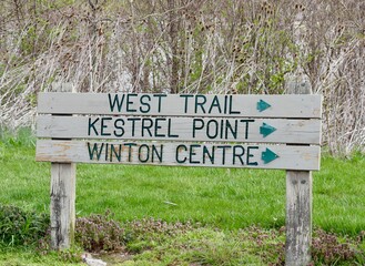 A close view of the old wood information sign.