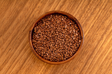 Chocolate gourmet sprinkles. Up view studio shoot isolated on white background.