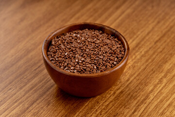 Chocolate gourmet sprinkles. 45 degree studio shoot isolated on wooden background.