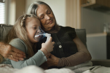 Senior woman taking care of her sick granddaughter.