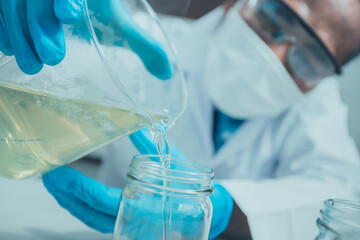 Scientists are conducting serious research into the development of ingredients for pharmaceutical and cosmetic products. To test formulas on lab beakers
