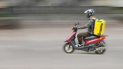 Fototapeta premium Abstract blur image of scooter courier