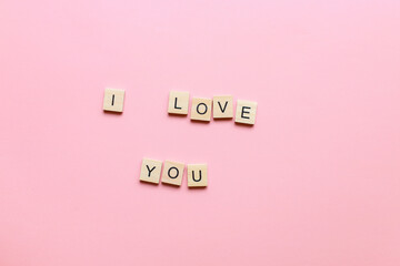 I love you made of wooden letters on a pink background. Flatly i love you. Lettering i love you