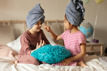 Little girl having fun during skincare routine.