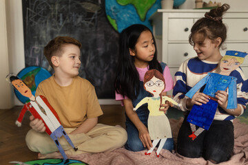 Little children playing with a handmade puppets.