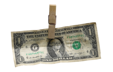 One dollar bill, banknote dry hanging on clothesline string with a clothespin, money laundering, isolated on white background