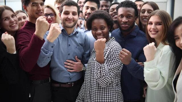 Confident diverse college students show fist up.