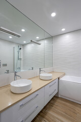 Fototapeta na wymiar white marble bathtub, sink and mirror