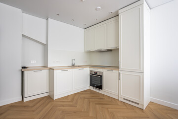 Fototapeta na wymiar empty white kitchen with cabinets, sink, stove