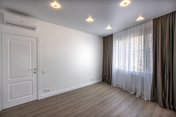 empty room without furniture with white walls and ceiling, curtains