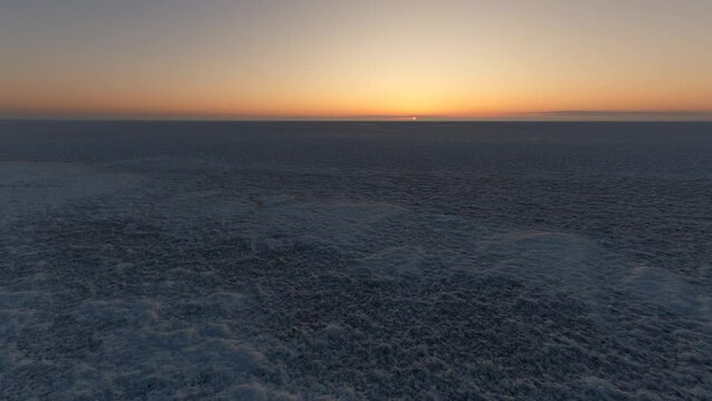 Sunrise time lapse on the Elton lake. Salt desert on a beach of Elton lake.