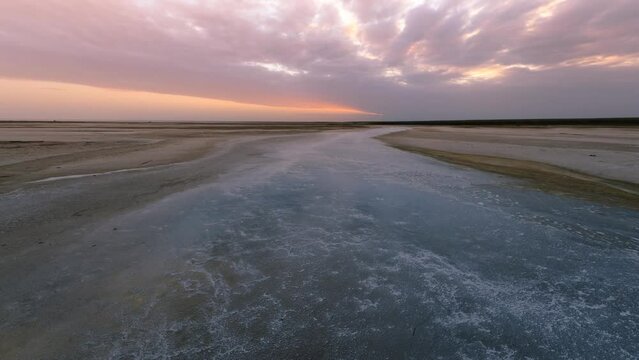 Time lapse of cloud sky at Sunset. Beautiful summer landscape with cloudy sky and salty river.