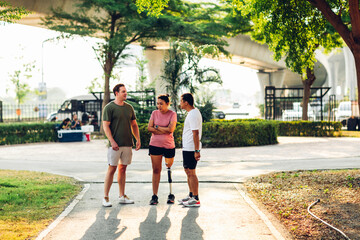 Fototapeta premium Friend support Friend with a prosthetic leg while exercising outdoor. People walking together on park outdoor. Exercise walking woman with prosthetic leg and friend support together in park outdoor