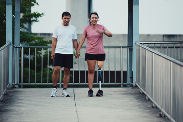 Friend support Friend with a prosthetic leg while exercising outdoor. People walking together on park outdoor. Exercise walking  woman with prosthetic leg and friend support together in  park outdoor