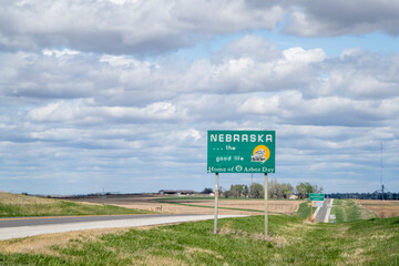 Nebraska, the good life, home of Arbor Day - roadside welcome sign at state border with Kansas, spring scenery