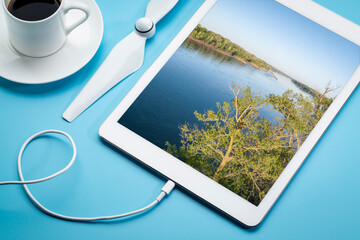 spring sunrise over the Missouri River at Dalton Bottoms - aerial image displayed on a digital tablet with a cup of coffee