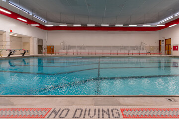 Public interior swimming pool / natatorium with tile lane lines.