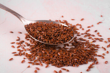 spoon with flax seed placed on a table