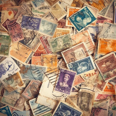 A pile of scattered, vintage postage stamps. generative AI