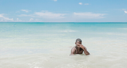 Fototapeta na wymiar Young black man enjoying Caribbean Sea
