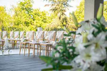 A beautiful wedding ceremony with flowers on the terrace at sunset