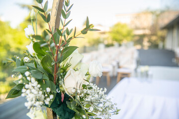A beautiful wedding ceremony with flowers on the terrace at sunset