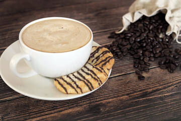 cup of coffee with beans and macaroons