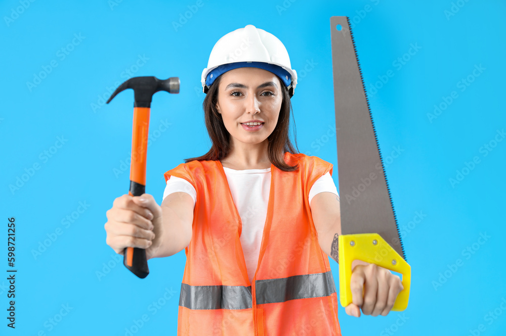 Sticker Female worker in vest and with tools on blue background