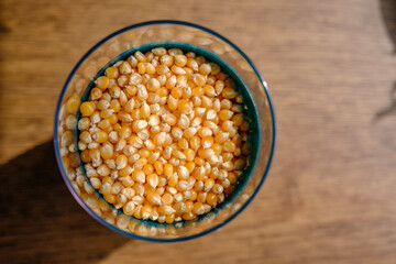 dried corn in a pot with a blurry wooden background