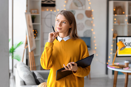 Female graphic designer working with tablet in office