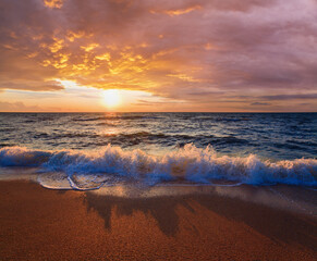 Naklejka na ściany i meble Sea sunset surf great wave break on sandy coastline