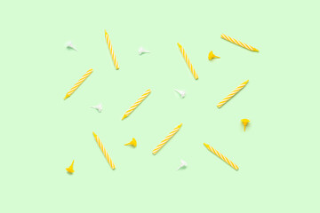 Yellow birthday candles on green background