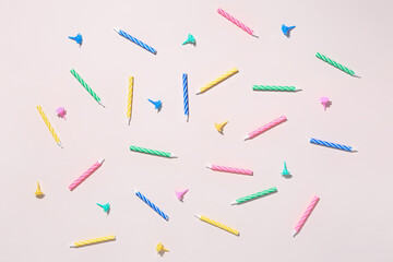 Colorful birthday candles on pink background