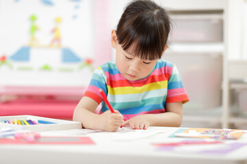  young girl  making craft for homeschooling