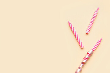 Pink birthday candles on beige background