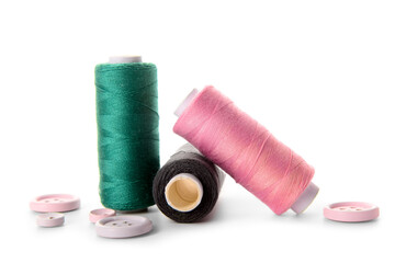 Thread spools and buttons isolated on white background