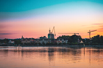 Beautiful sunrise view on Peters Glück contruction site from Imperia statue in early morning hours. Steamer harbor, Constance, Baden-Württemberg, Germany, Europe.