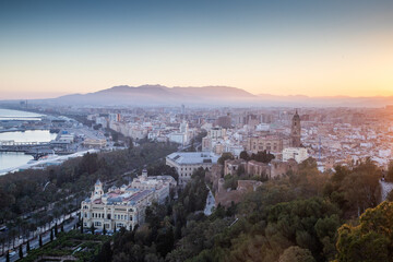 Obraz premium view over Malaga at sunset travel banner
