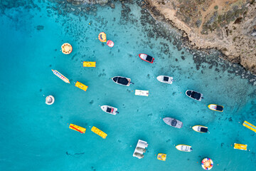 Aerial drone photograph of watersport boats moored anchored at the sea
