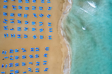 Drone aerial of beach chairs in a  tropical sandy beach. Summer holidays in the sea. Protaras...
