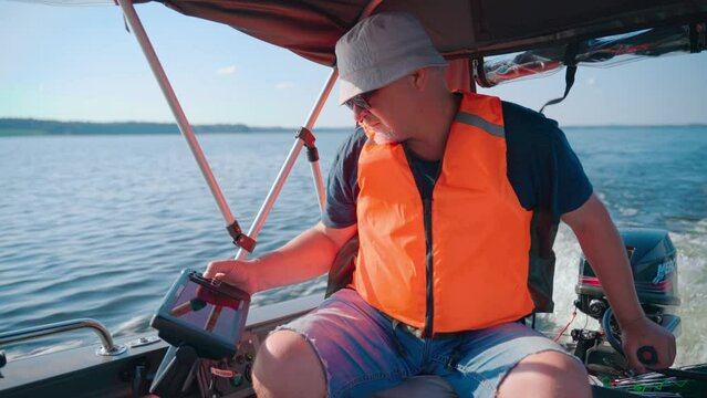 Braslav, Belarus, 05.08.22: A man in a motorboat operates an echo sounder Generative AI