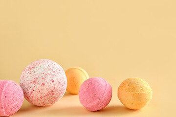 Bath bombs on beige background, closeup